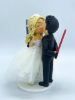 Picture of Tiny Bride & Tall Groom wedding cake topper, Bride is on Ladder kissing groom, Lightsaber Wedding Cake Topper