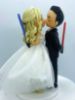 Picture of Tiny Bride & Tall Groom wedding cake topper, Bride is on Ladder kissing groom, Lightsaber Wedding Cake Topper